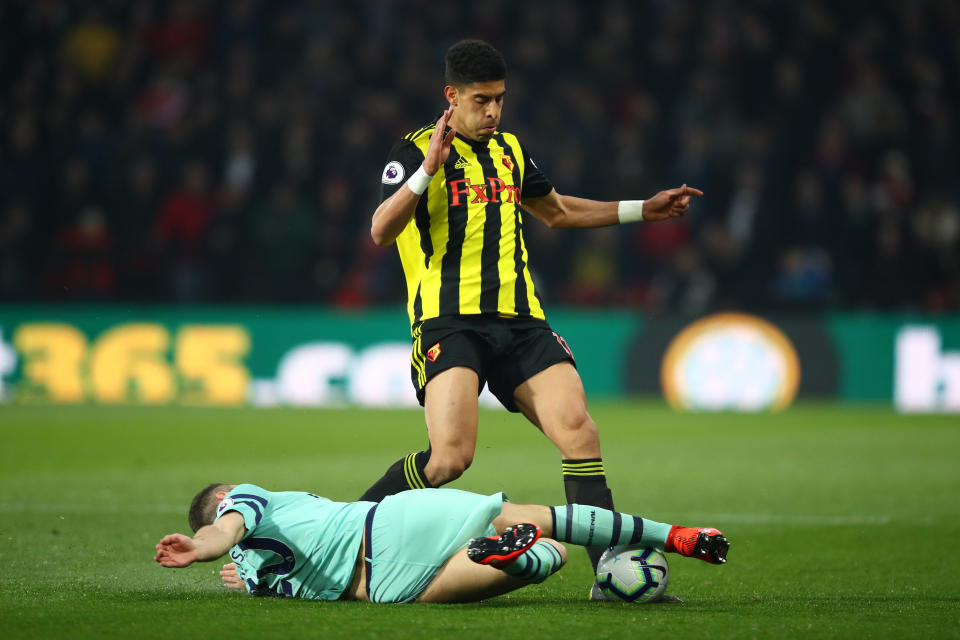 Adam Masina of Watford is tackled by Shkodran Mustafi