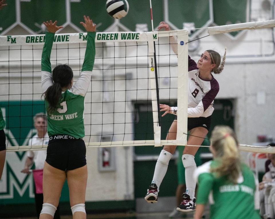 Olivia Znotens of Riverdale hits over Sydney Anderson of Fort Myers in the 6A Volleyball Regional Semifinals on Saturday, Oct. 28, 2023, in Fort Myers.