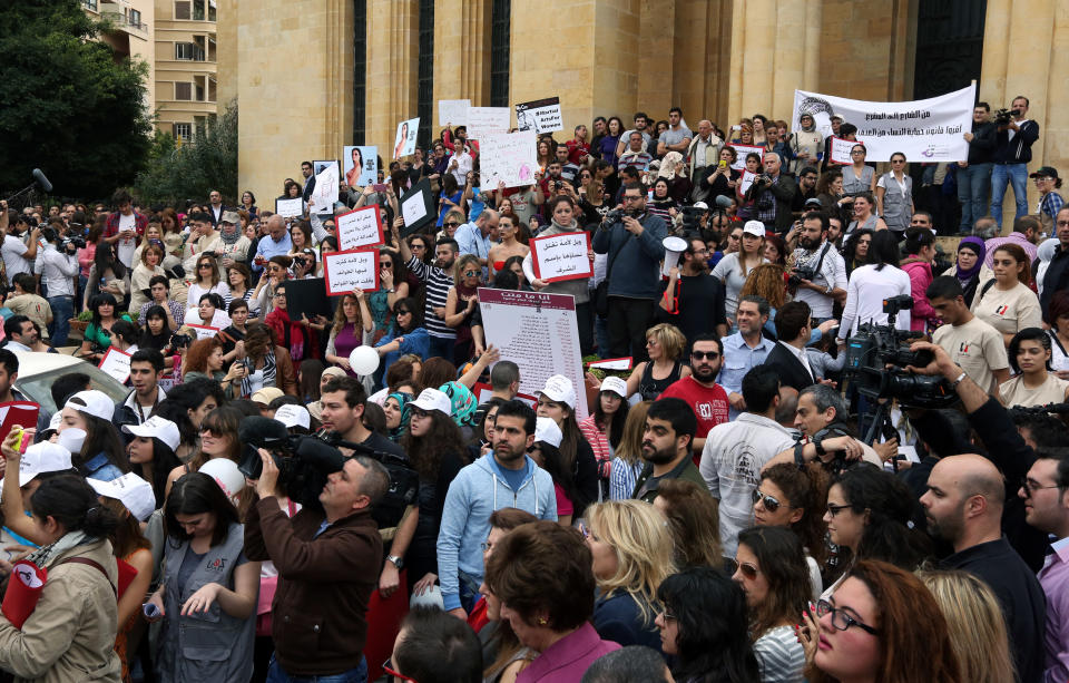 Lebanese citizens rally making International Woman's Day demanding that parliament approves a law that protects women from domestic violence in Beirut, Lebanon, Saturday, March 8, 2014. Several cases of domestic violence slayings in Lebanon in recent months, has drawn new attention to women’s rights in this country of 4 million people. Although Lebanon appears very progressive on women rights compared to other countries in the Middle East, domestic violence remains an unspoken problem and the nation’s parliament has yet to vote on a bill protecting women’s rights nearly three years after it was approved by the Cabinet. (AP Photo/Bilal Hussein)