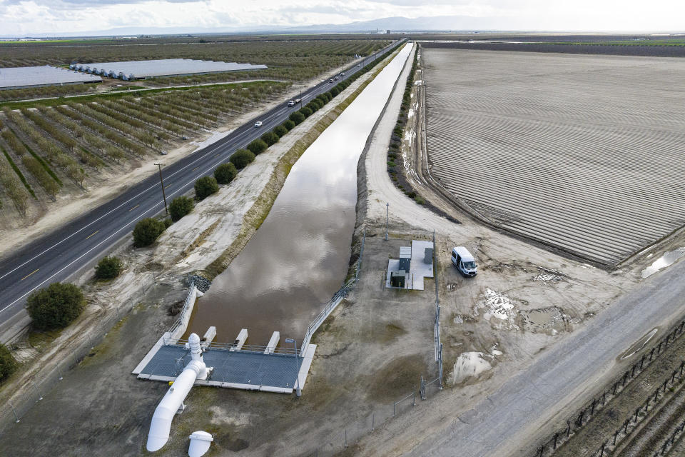 In this aerial drone photo provided by the California Department of Water Resources, the primary pump seen in the foreground is an element of a groundwater recharge project designed to move floodwater diverted from the Kings River to areas of Terranova Ranch that is part of a project designed to capture excess flow for groundwater storage in Fresno County on March 13, 2023. (Andrew Innerarity/California Department of Water Resources via AP)