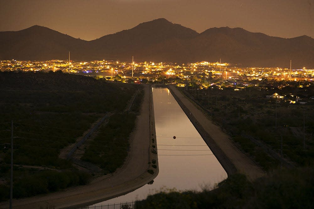 The Central Arizona project canal heads towards a neighborhood in Phoenix as seen from the Deem Hills Recreation Area on December 12, 2018.