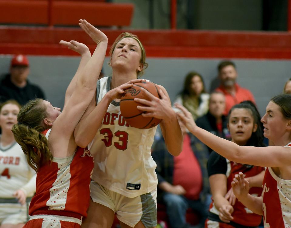 Bedford's Victoria Gray takes the ball inside against Monroe during the Mules' 55-33 win over Monroe in the semifinals of the Division 1 District at Bedford on Wednesday, March 6, 2024.
