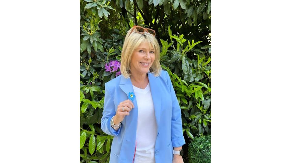 Ruth Langsford wearing blue blazer posing in garden of home with Eamonn Holmes 