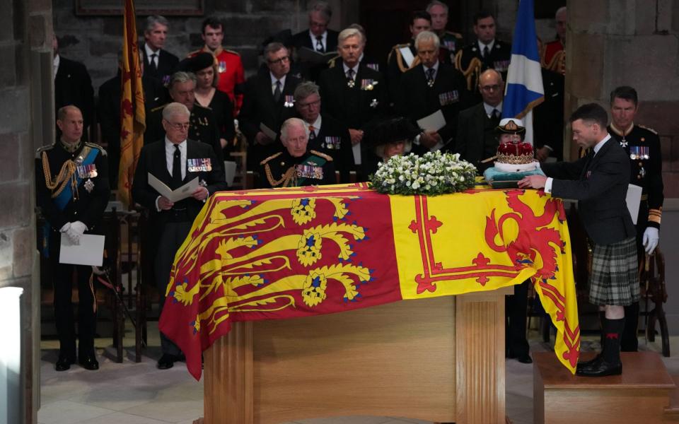 (LtR) The Earl of Wessex, the Duke of York, King Charles III, the Queen Consort, the Princess Royal and Vice Admiral Sir Tim Laurence, look on as the Duke of Hamilton places the Crown of Scotland on the coffin  -  Aaron Chown/PA