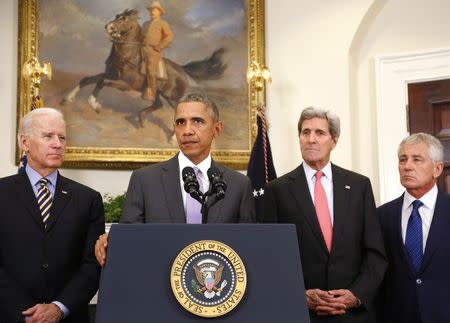 President Obama is flanked by Vice President Joe Biden, Secretary of State John Kerry and Defense Secretary Chuck Hagel as he delivers a statement on legislation sent to Congress to authorize the use of military force against the Islamic State, from the Roosevelt Room at the White House, February 11, 2015. REUTERS/Jonathan Ernst