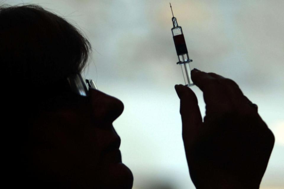 File photo dated 05/10/09 of a nurse preparing to give a patient a vaccine: PA