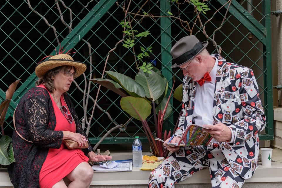 Mary and Bruce Throne of Baldwinsville, NY., plan out their betting strategy at the 149th running of the Kentucky Derby in Louisville, Ky. May 6, 2023