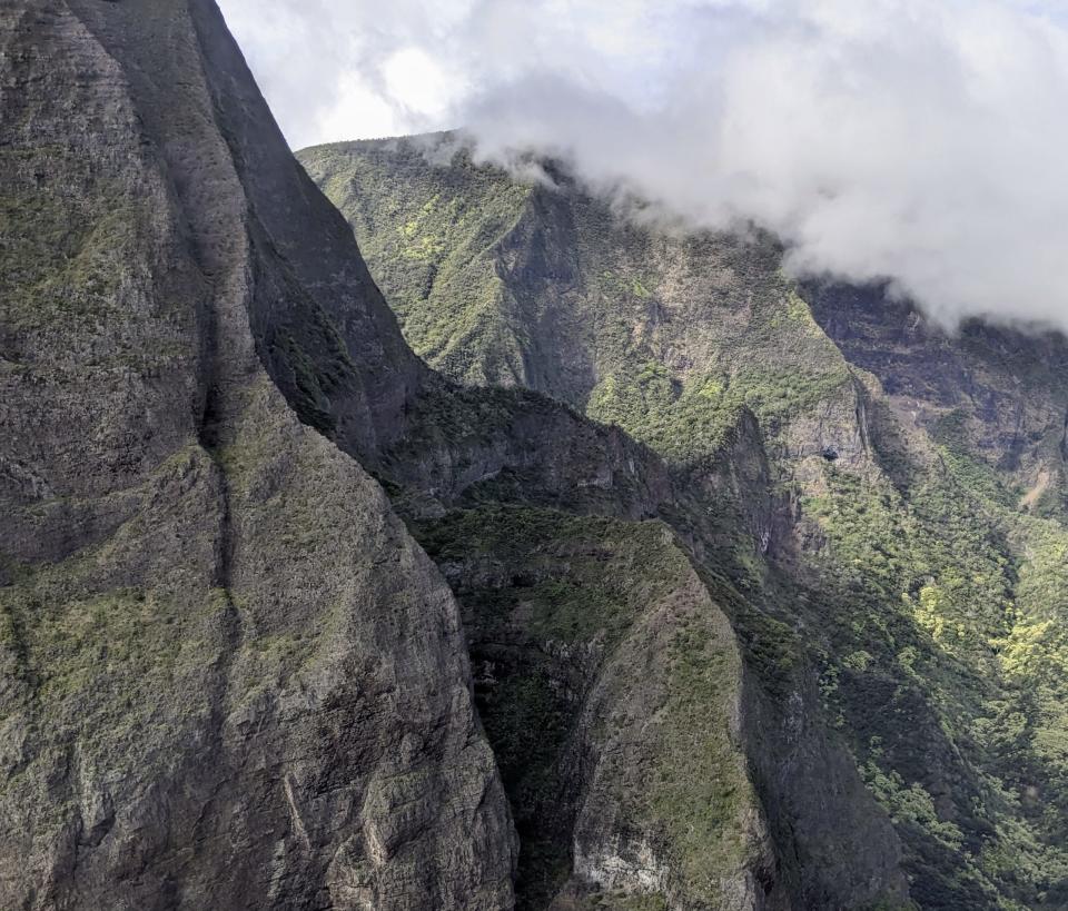 Molokai is a Hawaiian island that is quaint and private. 
Pictured: the green mountains of Molokai island