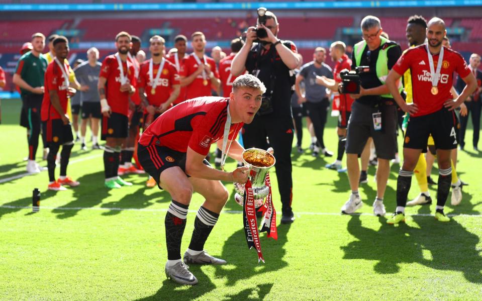 Rasmus Hojlund celebrates with the trophy in front of the United supporters