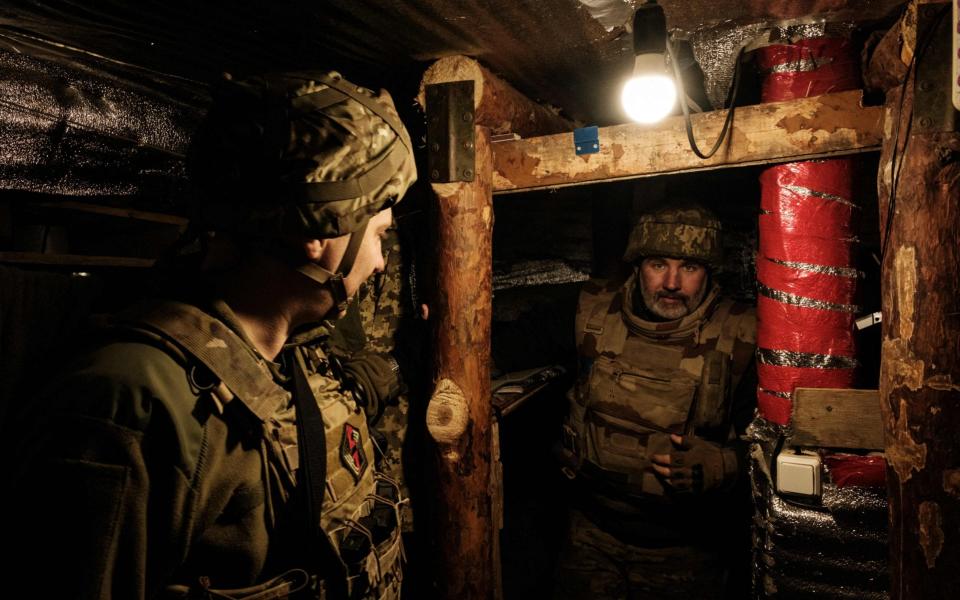 Soldiers of Ukraine's 5th Regiment of Assault Infantry react in their bunker at a front line near Toretsk in Donetsk - YASUYOSHI CHIBA/AFP