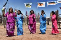 Indigenous people from the Tohono O'odham ethnic group dance and sing to protest against US President Donald Trump's intention to build a new wall in the border between Mexico and United States, in the Altar desert, northern Mexico