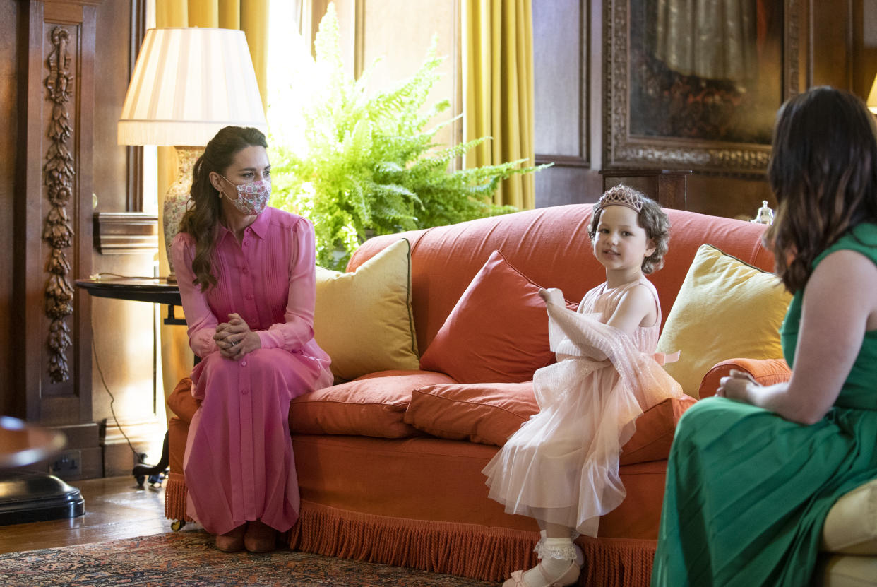 Catherine, Duchess of Cambridge wore a pink Me+Em dress during her meeting with Mila Sneddon at the Palace of Holyroodhouse, in Scotland, on May 27, 2021, as she promised the five-year-old she would match in her favourite colour. (Getty Images)