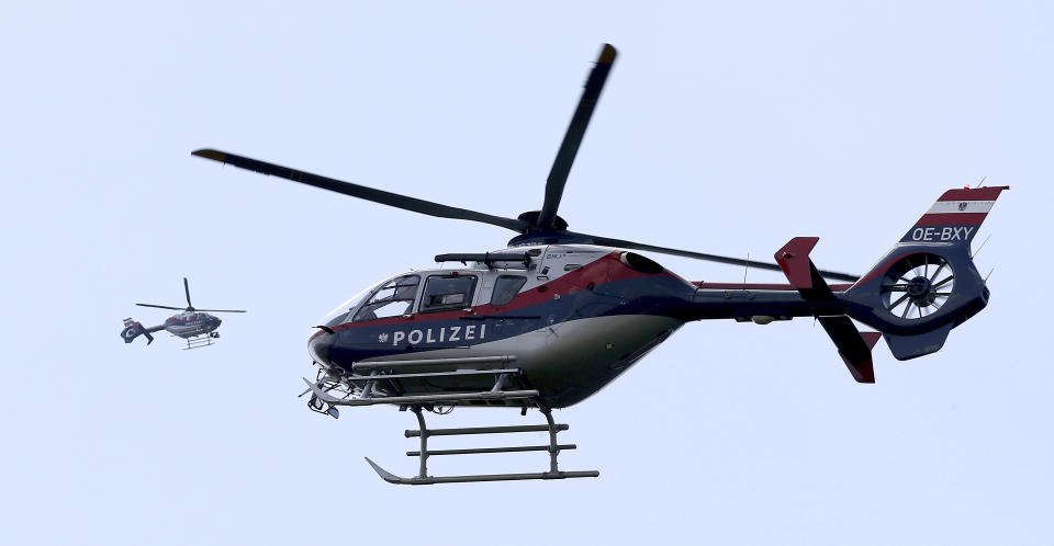 Police helicopters secure the car convoy of Russian President Vladimir Putin who arrives for the wedding from Austrian Foreign Minister Karin Kneissl with Austrian businessman Wolfgang Meilinger in Sulztal an der Weinstrasse, Austria, Satursday, Aug. 18, 2018. (AP Photo/Ronald Zak)