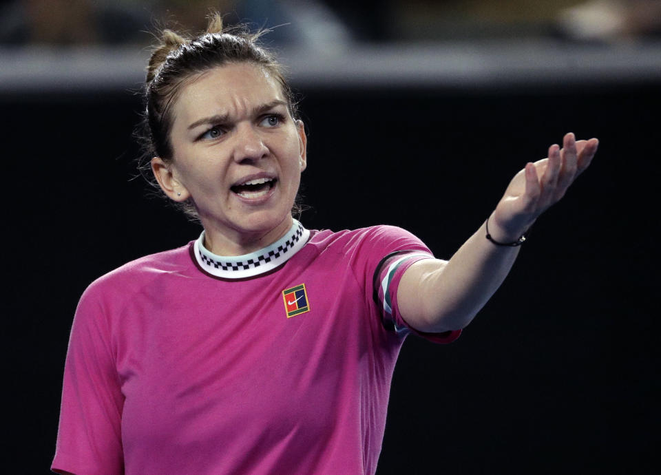 Romania's Simona Halep gestures during her first round match against Estonia's Kaia Kanepi at the Australian Open tennis championships in Melbourne, Australia, Tuesday, Jan. 15, 2019. (AP Photo/Mark Schiefelbein)