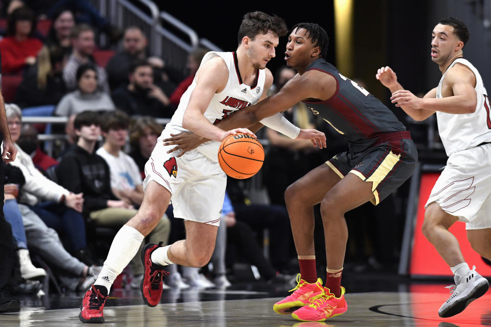 Louisville forward Matt Cross, left, tries to get around Boston College forward Gianni Thompson during the first half of an NCAA college basketball game in Louisville, Ky., Wednesday, Jan. 19, 2022. (AP Photo/Timothy D. Easley)