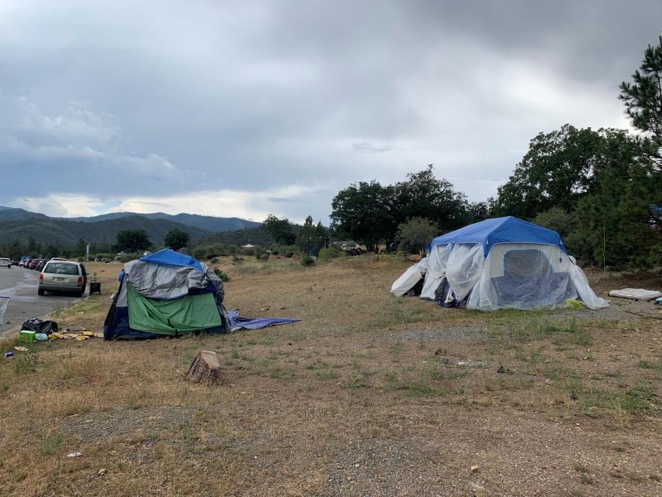 Tents housing homeless people stand on a hillside near the Siskiyou County Department of Behavioral Health in Yreka on June 8, 2023.