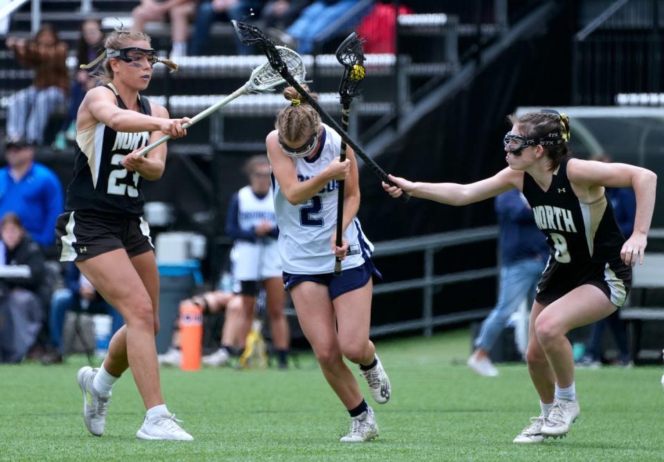 North Kingstown defenders Emily Kallman and Alexa Hanrahan try to stop charging Burrillville Bronco Kaitlyn Potter during 2nd half action. 