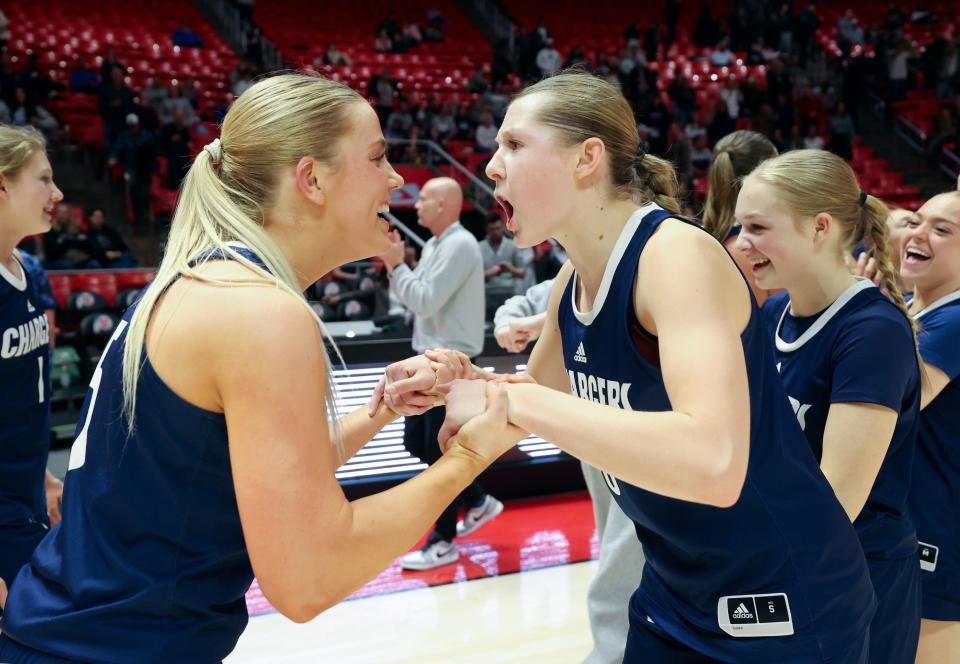 Corner Canyon players celebrate beating Davis High School in a 6A girls quarterfinal basketball game at the Huntsman Center in Salt Lake City on Monday, Feb. 26, 2024. Corner Canyon won 59-56 in overtime. | Kristin Murphy, Deseret News