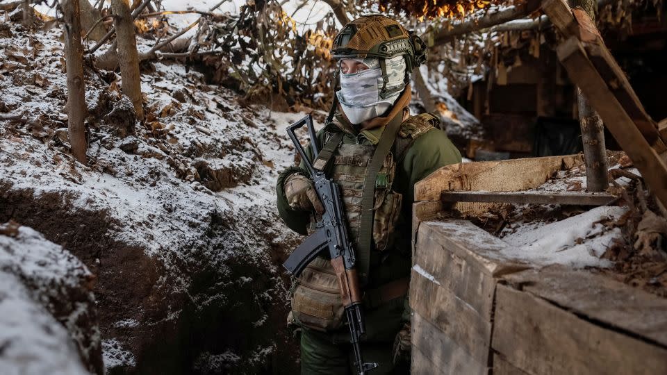 A Ukrainian serviceman stands at his position in a trench at a front line on the border with Russia in Sumy region, Ukraine, on January 20, 2024. - Gleb Garanich/Reuters