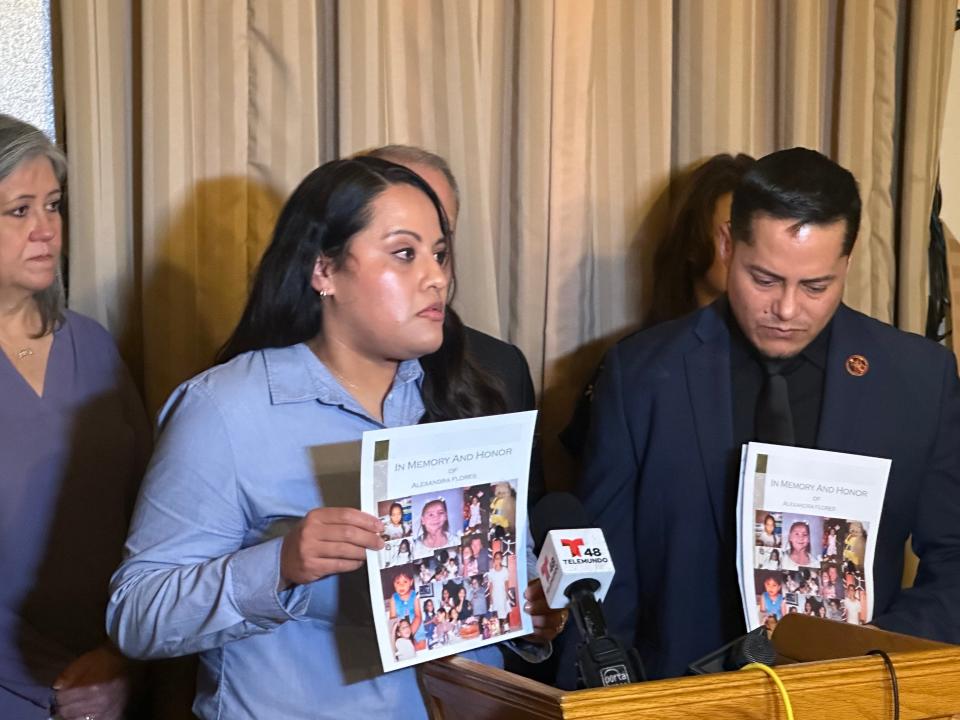 Alexandra Flores' siblings, Sandra Frausto and Ignacio Frausto, hold up a poster with photos of their sister at a news conference Nov 16, 2023, at the Texas Department of Criminal Justice's Huntsville Unit after the execution of the man, David Santiago Renteria, who abducted and killed Alexandra in 2001.