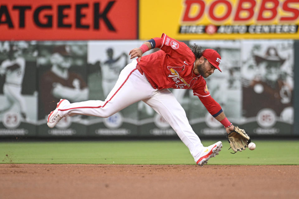 St. Louis Cardinals shortstop Brandon Crawford is unable to field a grounder by Cincinnati Reds' Spencer Steer during the first inning of a baseball game Friday, June 28, 2024, in St. Louis. (AP Photo/Joe Puetz)