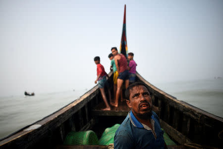 Rohingya refugees crew a fishing boat in the Bay of Bengal near Cox's Bazaar, Bangladesh, March 24, 2018. REUTERS/Clodagh Kilcoyne