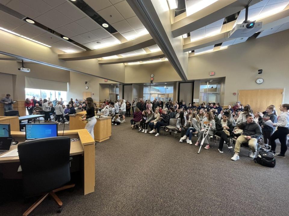 A group of parents, students, coaches and gymnastics alumni prepare to speak to the Sioux Falls School District Board of Education on March 27, 2023 about the need to save the gymnastics program.