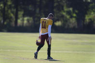 FILE - Washington quarterback Alex Smith (11) walks on the field before practice at the team's NFL football training facility in Ashburn, Va., in this Tuesday, Aug. 18, 2020, file photo. Smith announced his retirement Monday, April 19, 2021, on Instagram, saying he still has plenty of snaps left him just shy of his 37th birthday but is calling it quits to enjoy time with his family. (AP Photo/Alex Brandon, File)