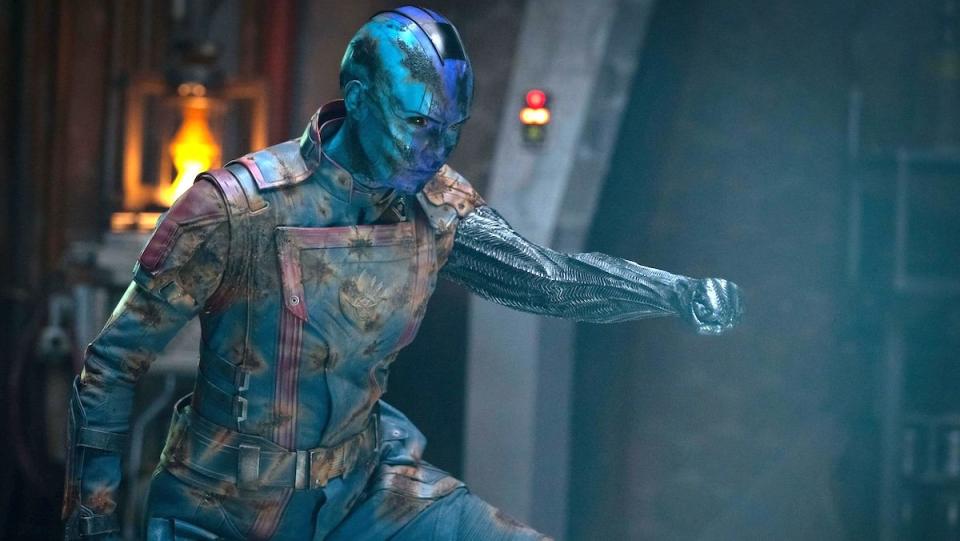 A battered NEbula on her knees with her arm extended as a weapon in Guardians of the Galaxy Vol. 3