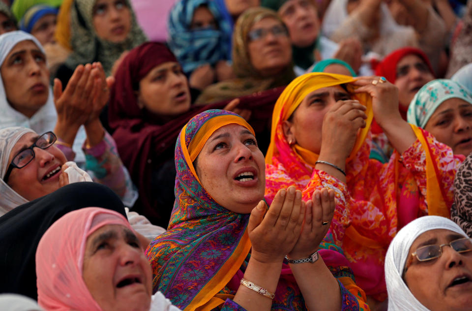 Kashmiri Muslim women cry and pray upon seeing a relic, believed to be a hair from the beard of Prophet Mohammad, displayed to devotees on the death anniversary of Hazrat Ali, son-in-law of Prophet Mohammad, at Hazratbal shrine during the holy month of Ramadan in Srinagar June 17, 2017. REUTERS/Danish Ismail
