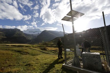 Glaciologist Christian Huggel checks the monitoring station he helped develop at Huascaran natural reserve in Ancash November 29, 2014. REUTERS/ Mariana Bazo