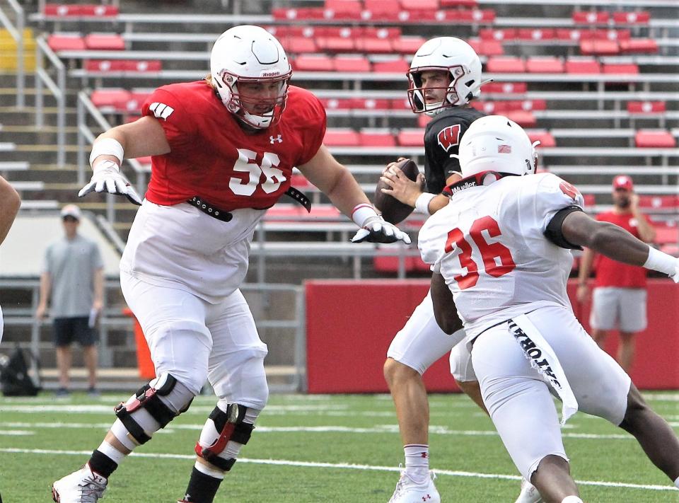 University of Wisconsin offensive lineman Joe Brunner (56) prepares to block linebacker Jake Chaney during the team's open practice on Sunday Aug. 21, 2022 at Camp Randall Stadium in Madison, Wis.