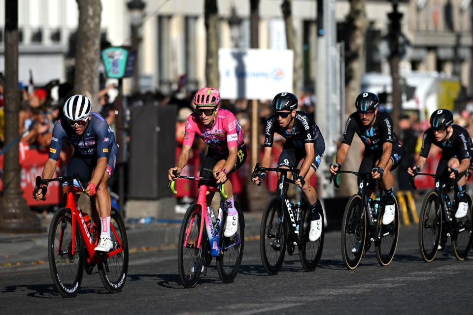 Five professional riders on the Champs Elysees at the 2022 Tour de France