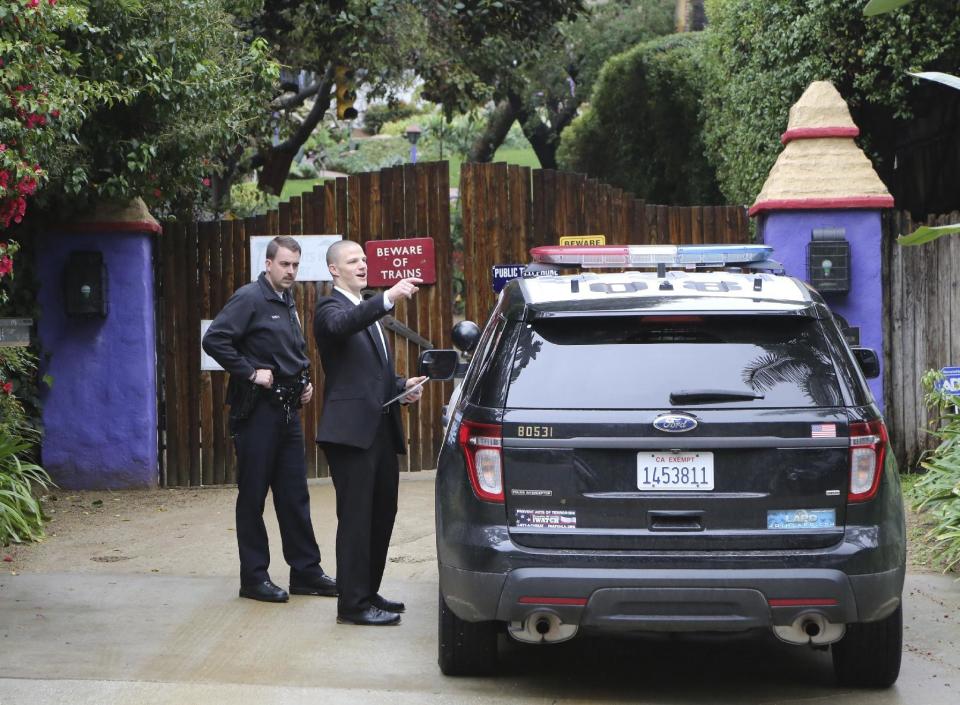 Los Angeles police officers and private security appear outside the homes of Debbie Reynolds and her daughter Carrie Fisher in Los Angeles Thursday, Jan. 5, 2017. Reynolds died Dec. 28 at the age of 84, a day after her daughter died at the age of 60. (AP Photo/Reed Saxon)