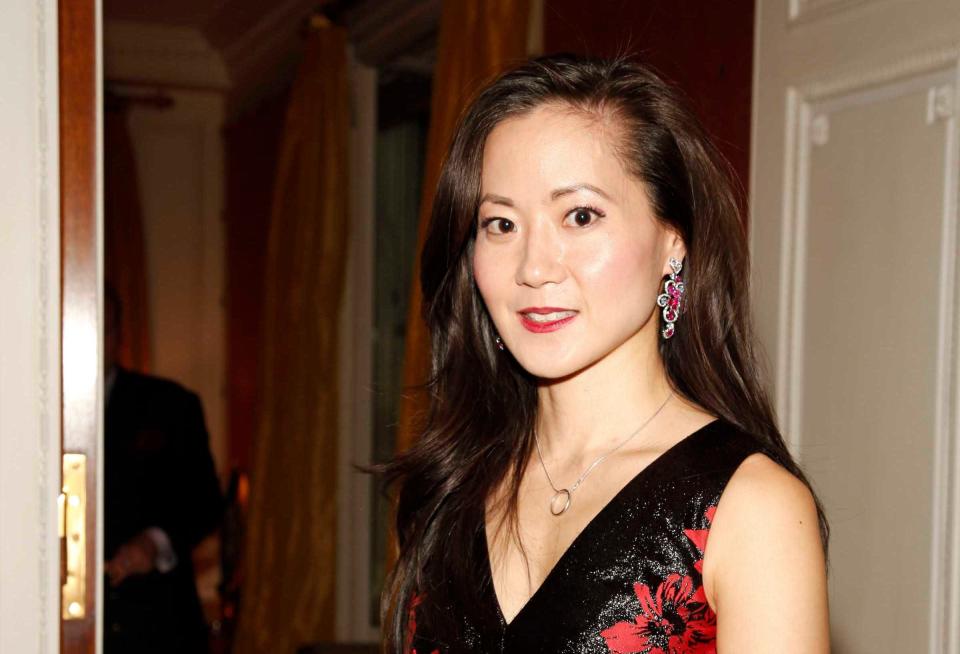 Angela Chao years before her death in a Tesla accident wearing a black and red dress and dangly red earrings