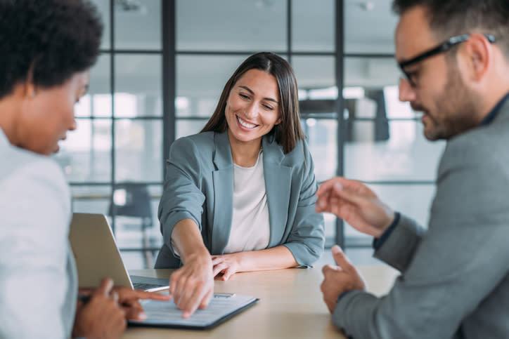 A couple meeting with a financial advisor to discuss financial planning tips for retirement.