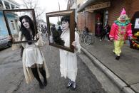 Babbette Hines, left, and Carol Jean Dixon, both of New Orleans, pose with their costumes representing sad ladies of the night, inspired by Storyville photographer E.J. Bellocq, before the start of the Society of Saint Anne walking parade in the Bywater section of New Orleans during Mardi Gras day, Tuesday, Feb. 12, 2013. (AP Photo/Gerald Herbert)