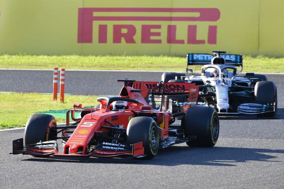 Ferrari's German driver Sebastian Vettel (L) leads Mercedes' British driver Lewis Hamilton (R) through a turn during the Formula One Japanese Grand Prix final at Suzuka on October 13, 2019. (Photo by Toshifumi KITAMURA / AFP) (Photo by TOSHIFUMI KITAMURA/AFP via Getty Images)