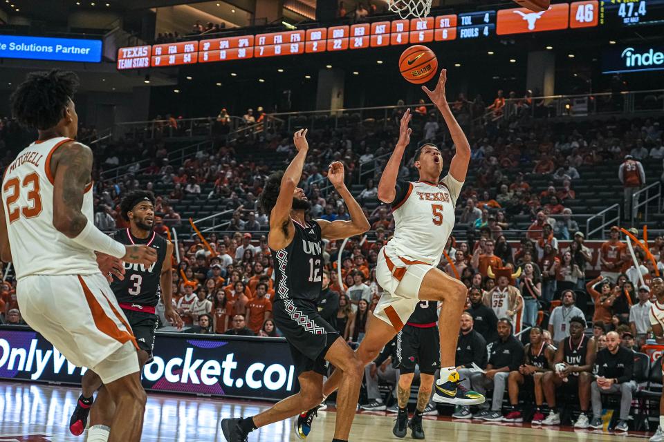 Texas forward Kadin Shedrick, right, gets off a shot while drawing a foul from Incarnate Word's Shon Robinson during Monday's 88-56 win at Moody Center. Recovered from offseason shoulder surgery, Shedrick impressed in his UT debut.