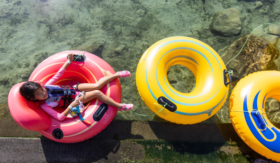 Vacationing with her family from St. Petersburg, FL, Ryann Paredes, 7, relaxes in her tub before shoving off on a tube excursion on the Rainbow River Thursday morning, July 7, 2022 in Dunnellon, FL from KP Hole. People were kayaking and tubing on the Rainbow River as temperatures were soaring into the mid 90's today with a heat index well into the 100's.   [Doug Engle/Ocala Star Banner]2022