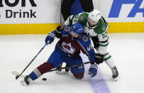 Colorado Avalanche defenseman Samuel Girard (49) gets tangled up with Dallas Stars center Wyatt Johnston (53) in the third period of Game 4 of an NHL hockey Stanley Cup playoff series Monday, May 13, 2024, in Denver. (AP Photo/David Zalubowski)