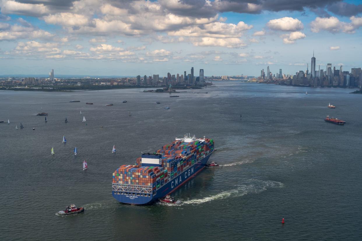 Tug boats assist a cargo ship in New York Harbor.