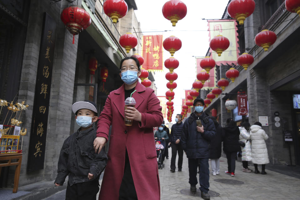 Visitors wearing masks are seen at Qianmen in Beijing. Source: The Yomiuri Shimbun via AP Images