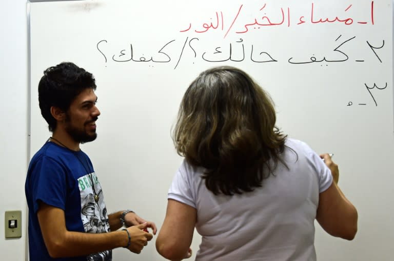 Syrian refugee Adel Bakkour (L) teaches Arabic in Rio de Janeiro, Brazil on April 20, 2017