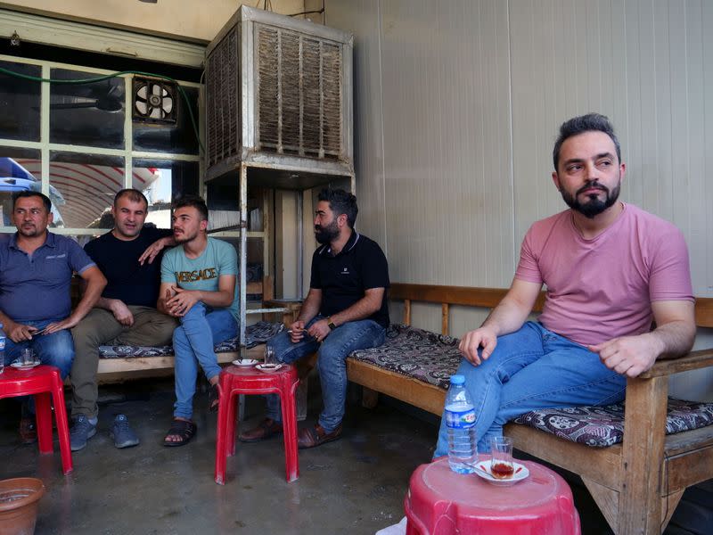 Abdullah Omar, a barber who has many relatives and friends who left to Belarus sits in a local tea shop in the town of Shiladze