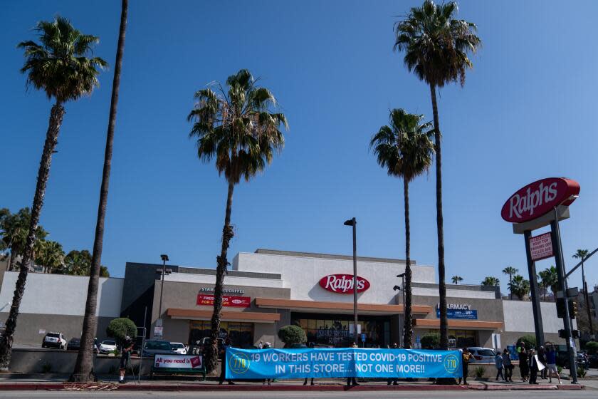 LOS ANGELES, CA - MAY 01: Grocery Store workers along with UFCW 770 representatives and community members hold a social distancing rally at the Hollywood Ralph's on Friday, May 1, 2020 in Los Angeles, CA. Workers at the Ralph's on Sunset have said that 19 employees have tested positive for COVID-19/Coronavirus and they are protesting working conditions for frontline/essential workers. (Kent Nishimura / Los Angeles Times)