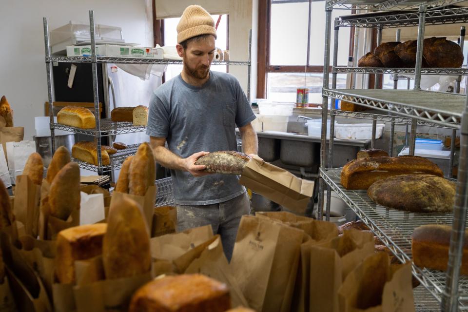 Aaron Hall of The Local Crumb packages bread in his studio in Mt. Vernon.