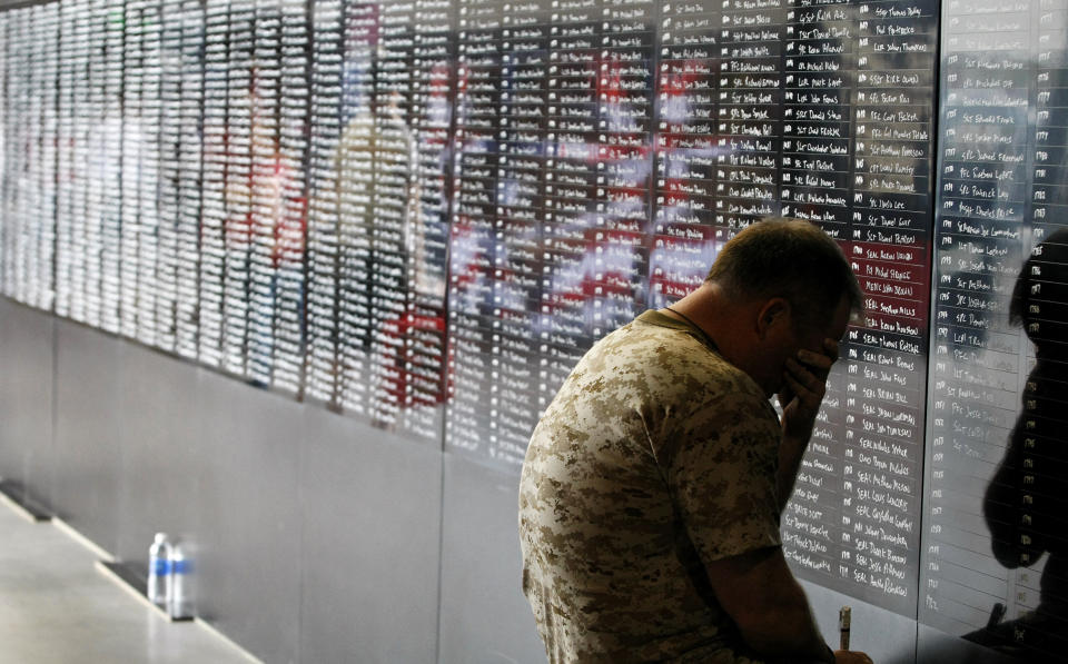 Navy veteran Ron White pauses to reflect for a moment as he adds the names of over 2,000 fallen military personnel who served in the war in Afghanistan to a 50-footwall at Chase Field during a&nbsp;Memorial Day game in&nbsp;Phoenix, Arizona, on May 27, 2013.