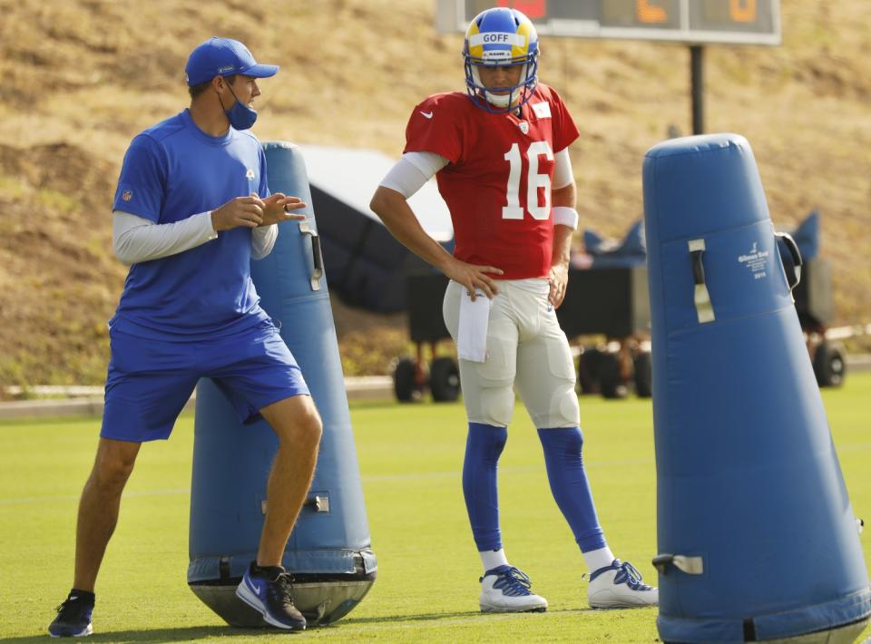 Rams offensive coordinator Kevin O'Connell works with quarterback Jared Goff during a practice session.