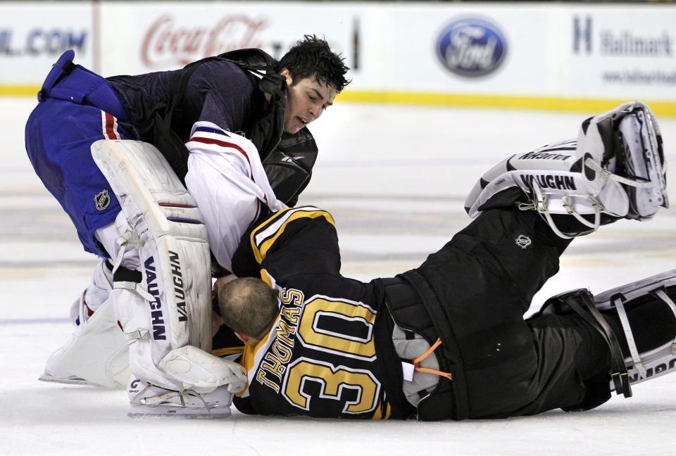 FILE - Montreal Canadiens goalie Carey Price, top, fights with Boston Bruins goalie Tim Thomas (30) during the second period of an NHL hockey game in Boston, Feb. 9, 2011. The league rule changes have made it so punitive that goalie fighting has essentially disappeared from the highest level of hockey. (AP Photo/Elise Amendola, File)